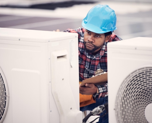 Professional working on HVAC system on commercial building