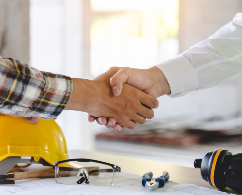 construction worker and contractor. Client shaking hands with team builder in renovation site