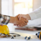 construction worker and contractor. Client shaking hands with team builder in renovation site